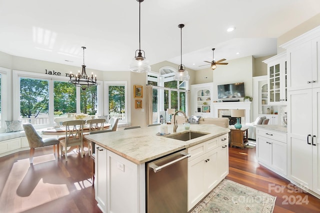 kitchen featuring light stone counters, an island with sink, dark wood-type flooring, white cabinetry, and dishwasher