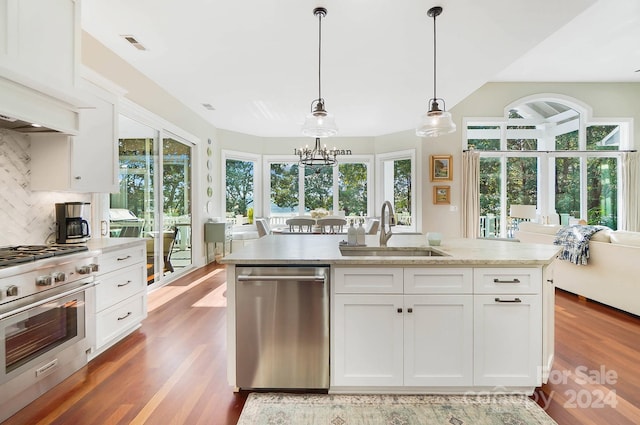 kitchen with a wealth of natural light, sink, stainless steel appliances, and white cabinets