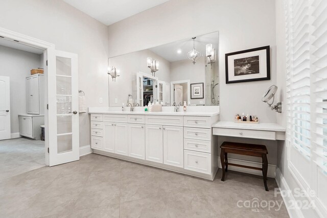 bathroom featuring vanity and a notable chandelier