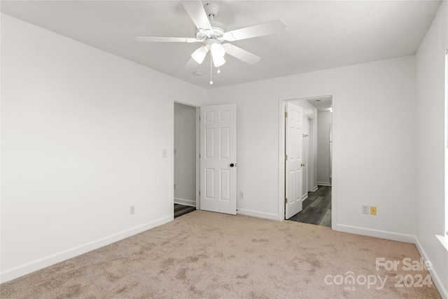 unfurnished bedroom featuring carpet flooring and ceiling fan