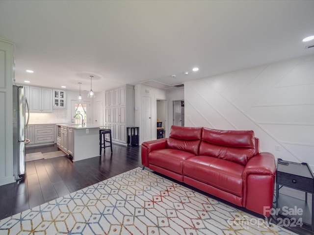 living room with dark hardwood / wood-style flooring and sink