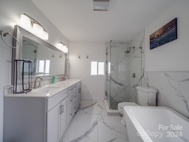 full bathroom featuring toilet, vanity, and independent shower and bath