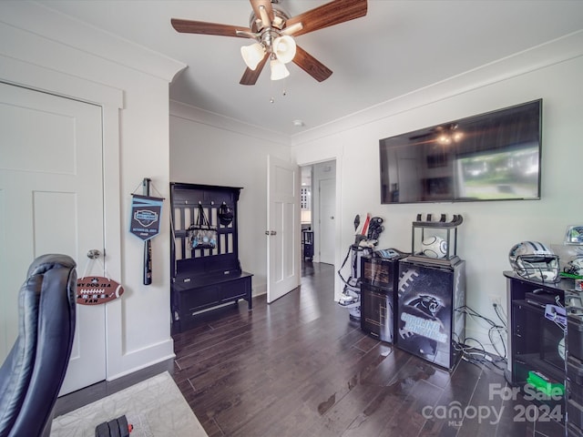 interior space featuring dark wood-type flooring, crown molding, and ceiling fan