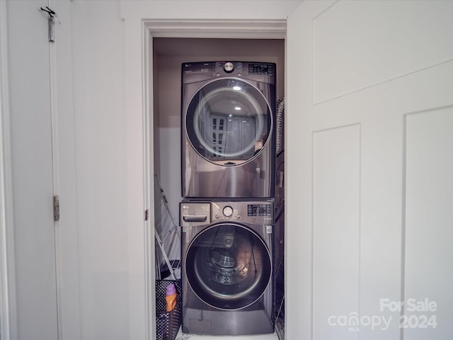 laundry room featuring stacked washer / drying machine