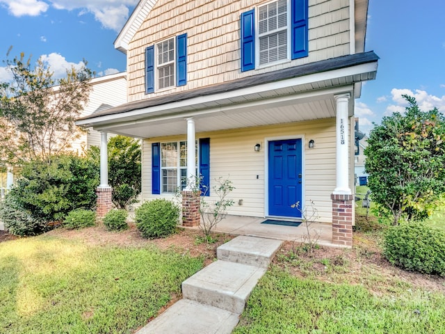 view of front facade with a front lawn and a porch