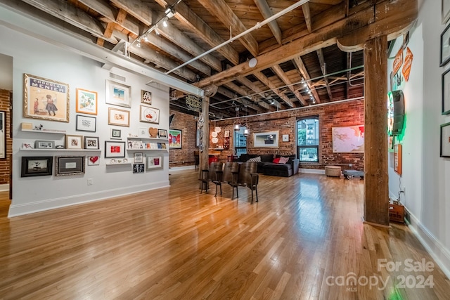 interior space featuring brick wall and hardwood / wood-style floors
