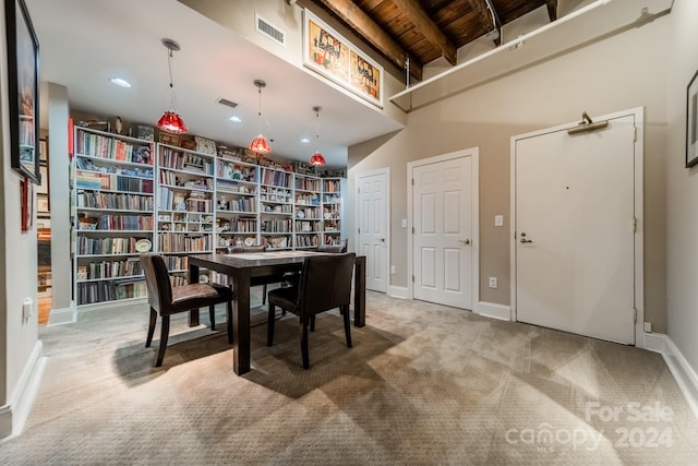 dining room with wood ceiling and carpet floors