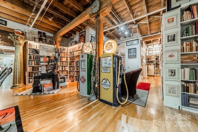 miscellaneous room with hardwood / wood-style flooring and water heater