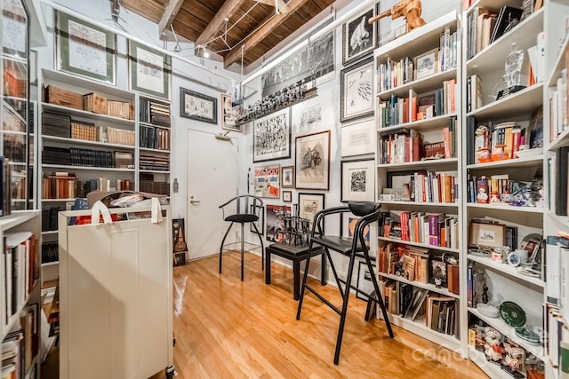interior space featuring wood-type flooring and beam ceiling