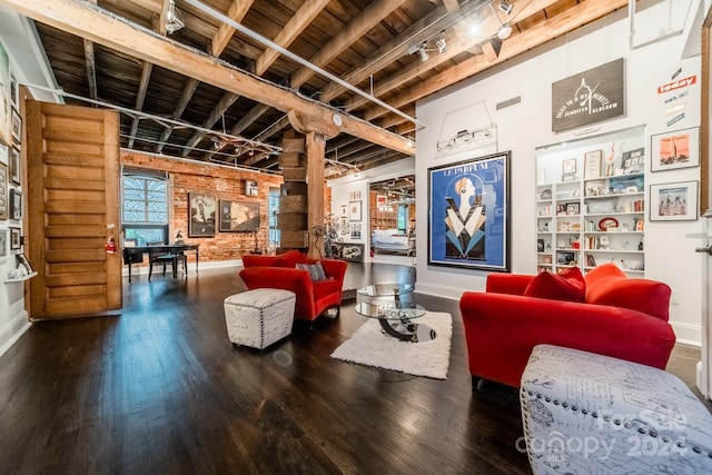 living room with beam ceiling, hardwood / wood-style floors, and rail lighting