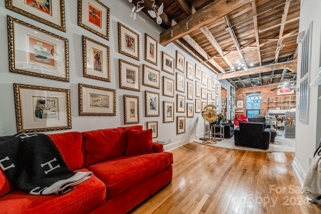 living room with wooden ceiling, lofted ceiling with beams, and hardwood / wood-style floors