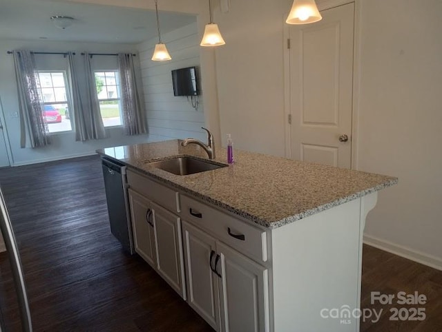 kitchen featuring a center island with sink, pendant lighting, white cabinetry, and sink