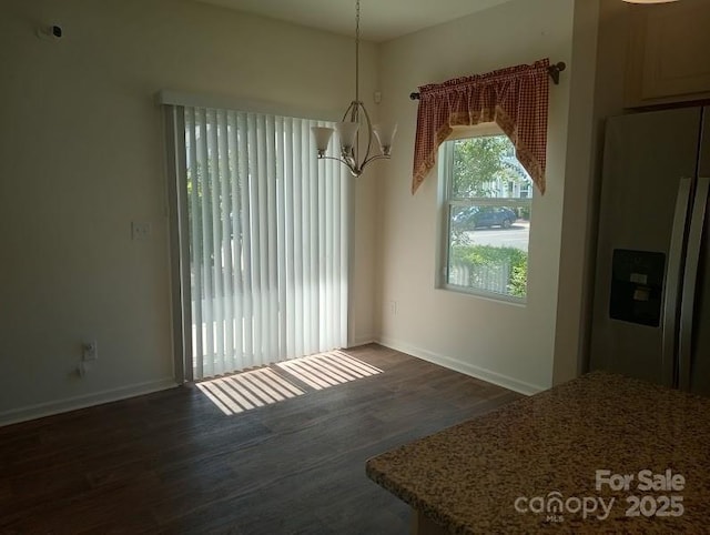 unfurnished dining area featuring an inviting chandelier