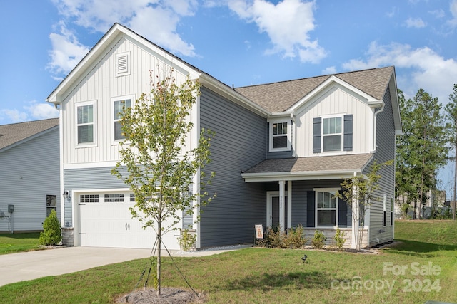 view of front of property with a garage and a front lawn