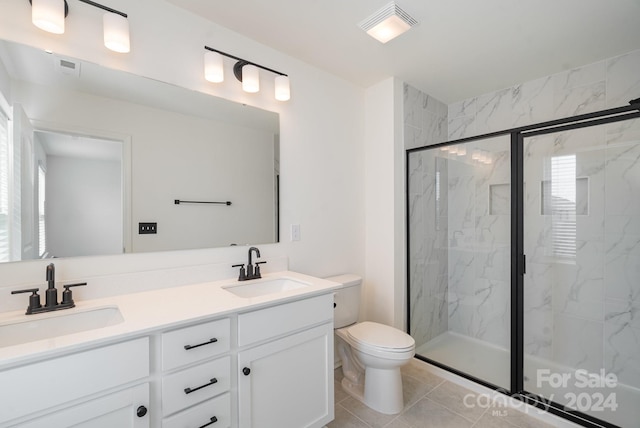 bathroom featuring vanity, tile patterned flooring, toilet, and walk in shower