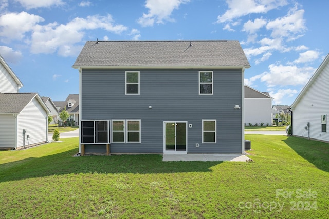 rear view of property featuring a patio area and a yard