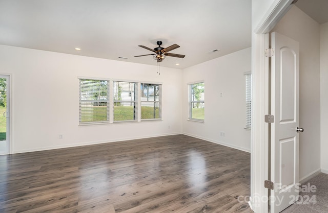 unfurnished room with ceiling fan and dark hardwood / wood-style floors