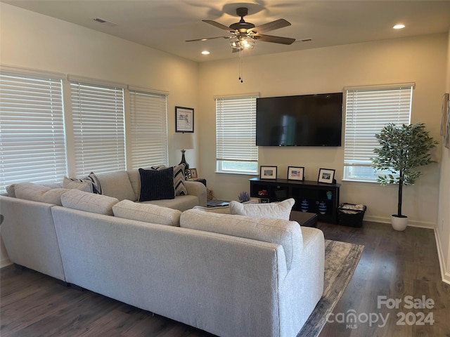 living room featuring dark hardwood / wood-style floors and ceiling fan