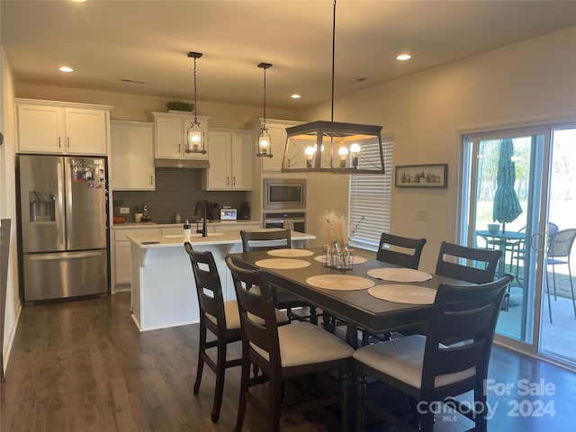 dining room with dark hardwood / wood-style flooring and a chandelier