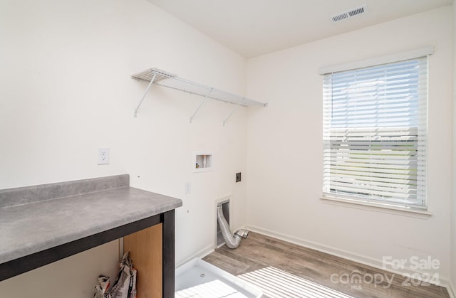 laundry room featuring electric dryer hookup, washer hookup, and hardwood / wood-style floors