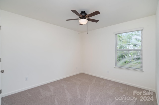 spare room with carpet and ceiling fan