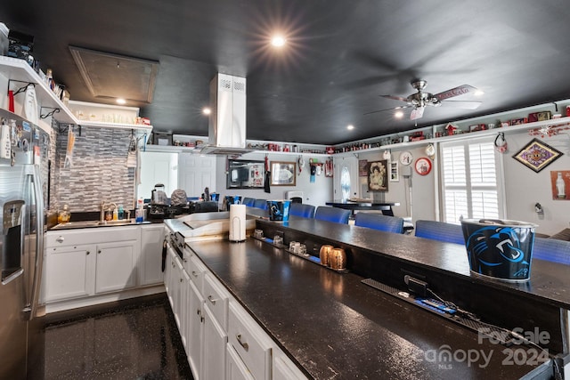 kitchen with ceiling fan, sink, stainless steel fridge with ice dispenser, white cabinetry, and exhaust hood