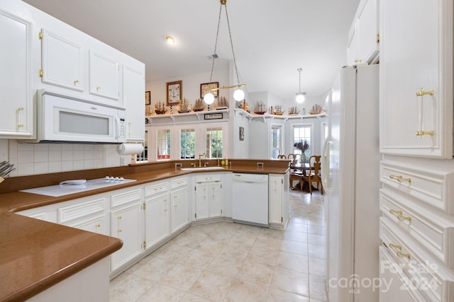 kitchen featuring hanging light fixtures, white cabinets, backsplash, white appliances, and kitchen peninsula