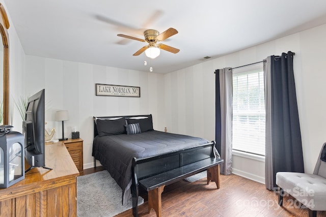 bedroom with ceiling fan and wood-type flooring