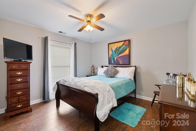 bedroom with dark hardwood / wood-style floors and ceiling fan