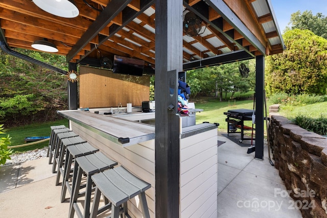 view of patio / terrace featuring a gazebo and an outdoor bar