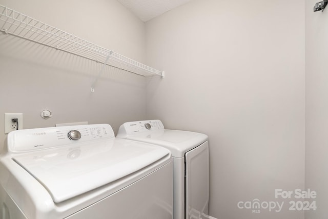 laundry area featuring washing machine and clothes dryer