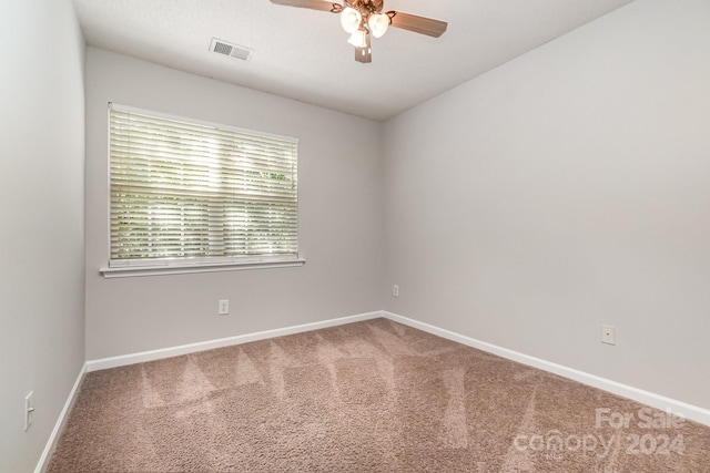 unfurnished room featuring ceiling fan and carpet