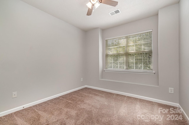 spare room featuring ceiling fan and carpet