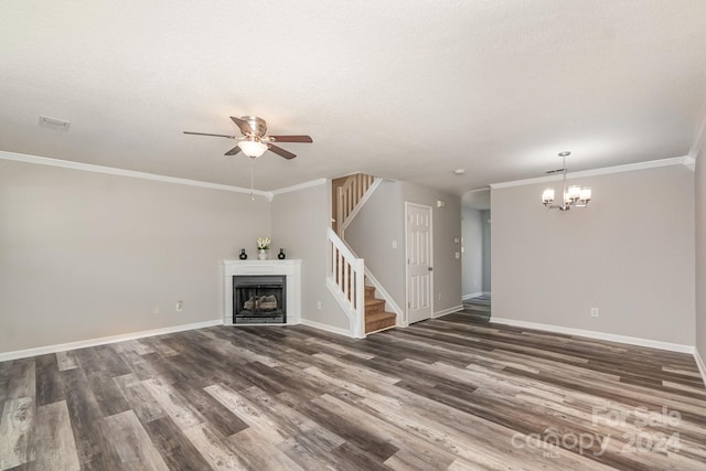 unfurnished living room with a textured ceiling, ceiling fan with notable chandelier, crown molding, and dark wood-type flooring