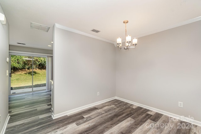 empty room with ornamental molding, a notable chandelier, and dark hardwood / wood-style flooring