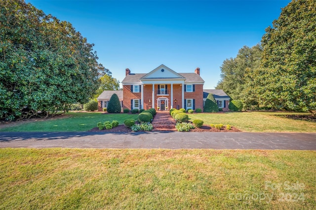 neoclassical home with a front lawn