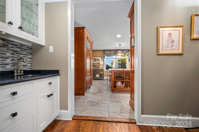 hall featuring sink and light hardwood / wood-style flooring