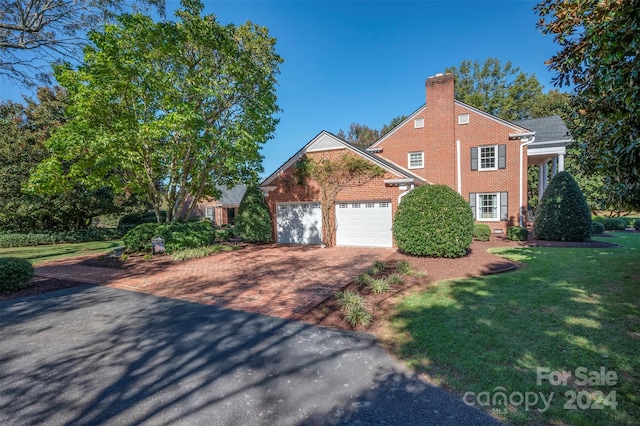 view of front property with a front yard and a garage