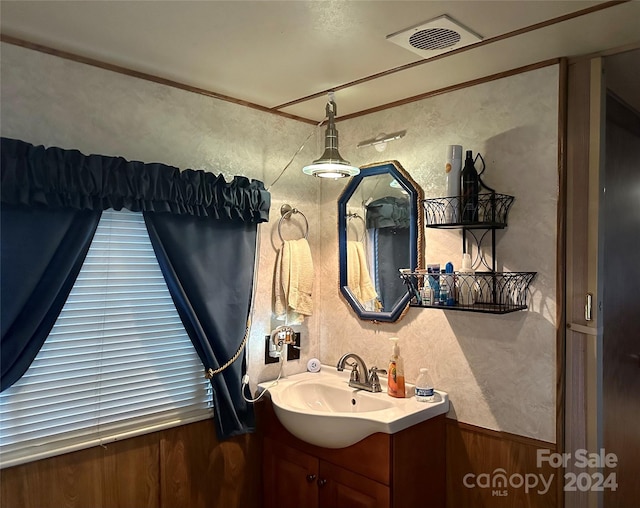 bathroom with vanity and crown molding