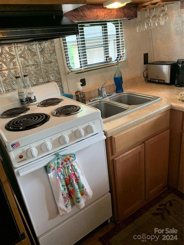 kitchen with white range with electric cooktop and sink