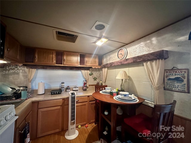 kitchen featuring light wood-type flooring, wine cooler, and white stove