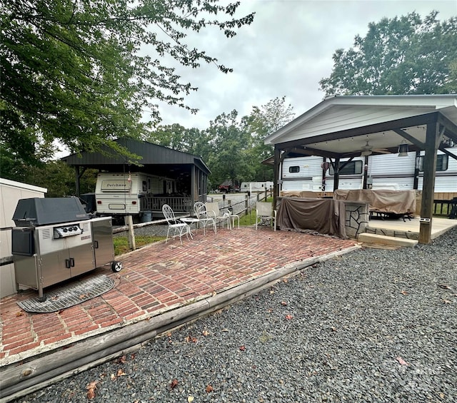 view of yard with ceiling fan, a gazebo, and a patio