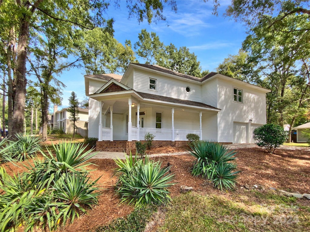 view of front of property featuring a garage and covered porch