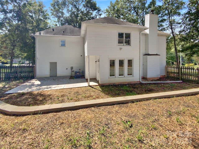 back of house with cooling unit and a patio