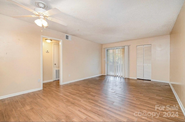 unfurnished bedroom featuring ceiling fan, a textured ceiling, and light hardwood / wood-style flooring