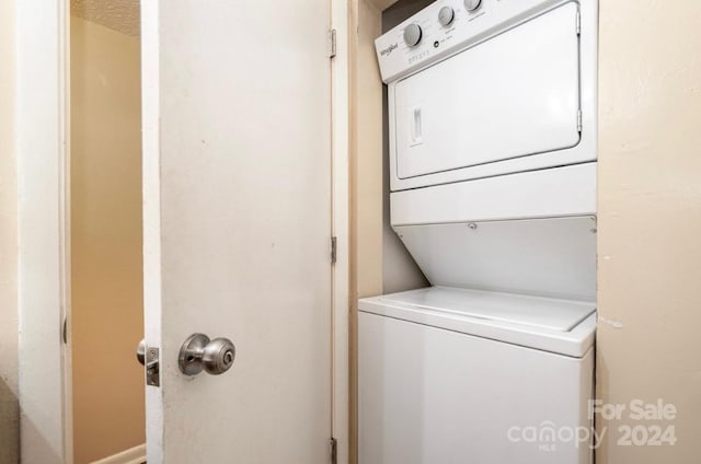 laundry area featuring stacked washer / dryer