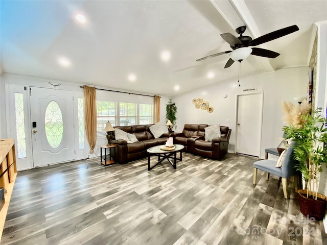 living room with lofted ceiling with beams, wood-type flooring, and ceiling fan