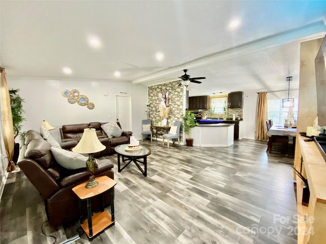 living room featuring ceiling fan and light hardwood / wood-style floors