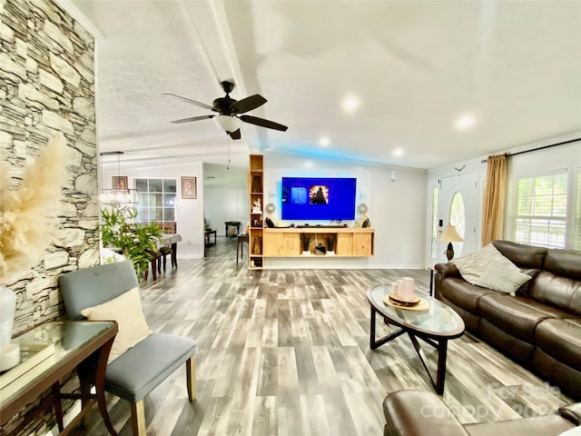 living room featuring ceiling fan, vaulted ceiling with beams, and light hardwood / wood-style flooring