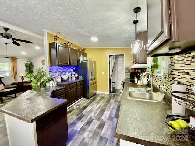 kitchen featuring pendant lighting, light hardwood / wood-style floors, stainless steel fridge with ice dispenser, sink, and dark brown cabinetry